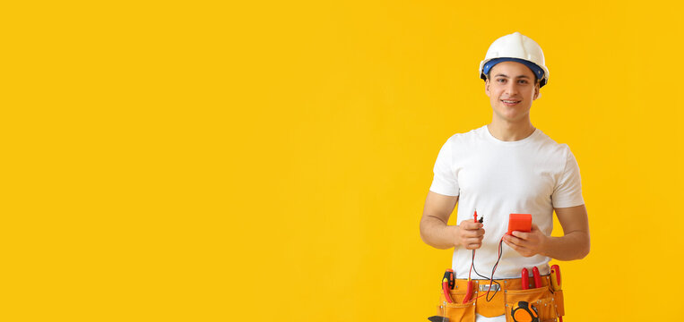 Young electrician with multimeter on color background