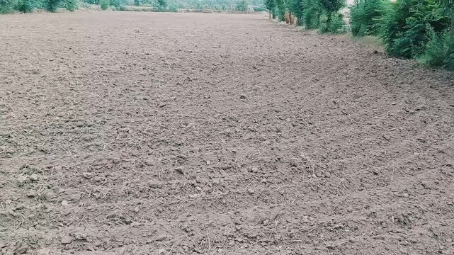 Wide panning shot of a freshly plowed agricultural field