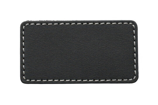 A rectangular black leather patch with white stitched borders, isolated on a black background, for clothing and, textile applications