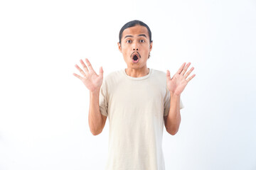 Naklejka premium Young Asian man in a shirt, with a shocked face expression. Isolated on a white background