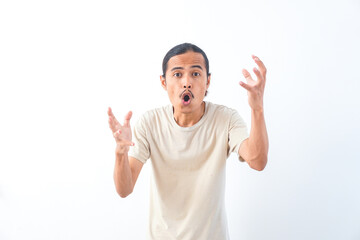 Fototapeta premium Young Asian man in a shirt, with a shocked face expression. Isolated on a white background