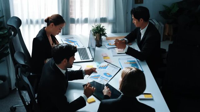 Top view of smart businesswoman discuss marketing plan at meeting while looking stock market investment chart from businessman. Group of diverse people analyze financial statistic plan. Directorate.