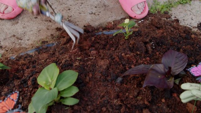 Mother And Child Gardening In Yard Planting Flowers In Front Of House Wearing Gloves Outdoor Family Lifestyle Scene Warm Emotional Bonding Perfect For Advertising Parenting And Gardening