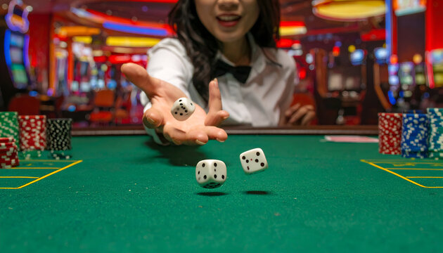 Woman throwing dice in a casino with slot machines in the background.
