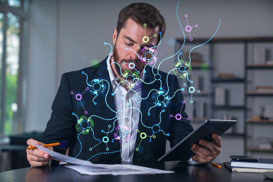 Considered businessman in formal wear signing contract holding tablet device at office room with papers. Concept of successful business deal, agreement, partnership, documents. Technology ai icons.