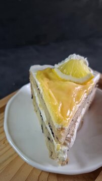 Slice of Lemon Blueberry Cake. Vertical Clip of Delicious Cake with Whipped Cream and Lemon Curd Topping