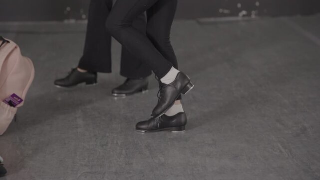 Group of young female tap dancers in a modern dance studio