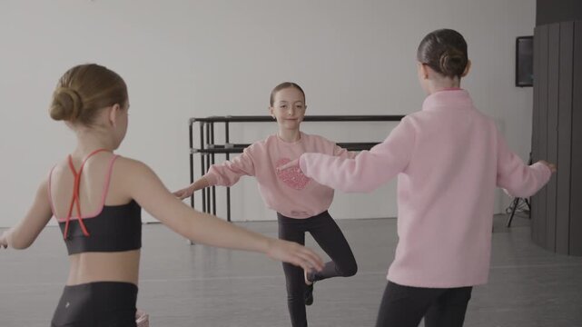 Group of young female tap dancers in a modern dance studio