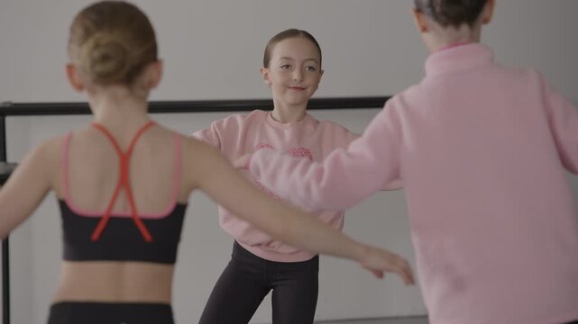 A Group of young female tap dancers in a modern dance studio