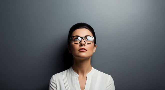 Serious beautiful businesswoman deep in thought perfect for professional corporate planning and problem solving concept