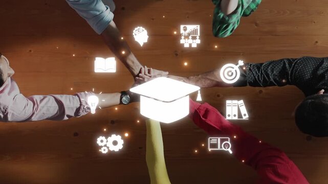 A captivating overhead view showing hands collaborating on ideas and goals. Educational icons surrounding a graduation cap represent a strong focus on learning and growth. Raster