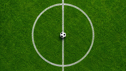 Obraz premium Top view of soccer ball placed at center circle on football field.