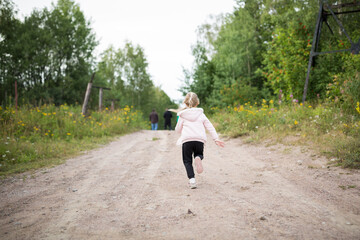 Fototapeta premium Child Running On Dirt Path In Green Park Outdoors During Daytime