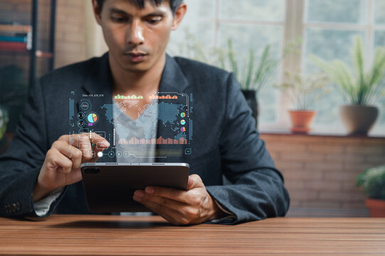 Businessman Analyzing Data with Digital Charts on Tablet Device