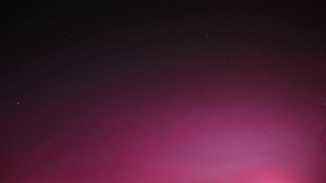 timelapse, time lapse, night sky background featuring a soft purple gradient fading into black with scattered stars. Abstract space texture useful for wallpapers
