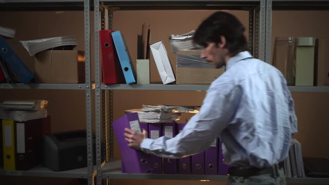 Man beside storage shelves in an office