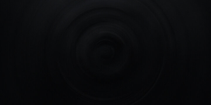 Dark circular motion pattern creating deep tunnel effect with subtle radial blur focused toward central point of black surface.