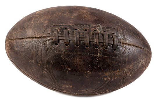 Antique brown leather American football with worn texture isolated on a clean white studio background