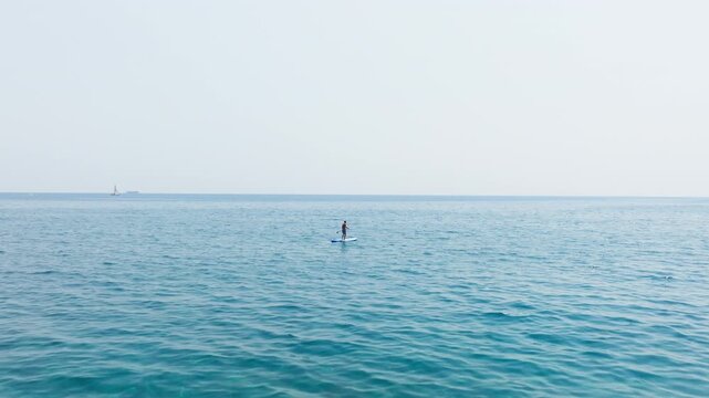 Man Feeling Free With The SUP Sailing The Ocean 