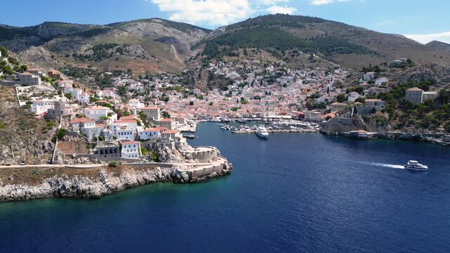 Aerial Greek Island of Hydra Harbor Port. Drone Slowly In Entrance as Ferries and Boats Enter. Greece European Summer Vacation Destination Travel