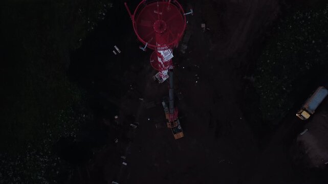 Aerial view of red offshore platform in dark water
