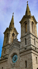 Fototapeta premium Charles's Church, a distinguished stone building with two spires and a prominent clock, representing Tallinn's religious heritage and historical architecture under a clear summer sky