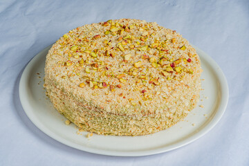 Obraz premium Delightful dessert featuring a rich, nutty cake topped with crushed pistachios for a special celebration