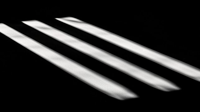Three parallel lines of varying thicknesses against a black background.