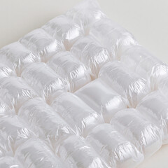 Fototapeta premium A close up view of clear plastic air cushion packaging material lying on a plain white background