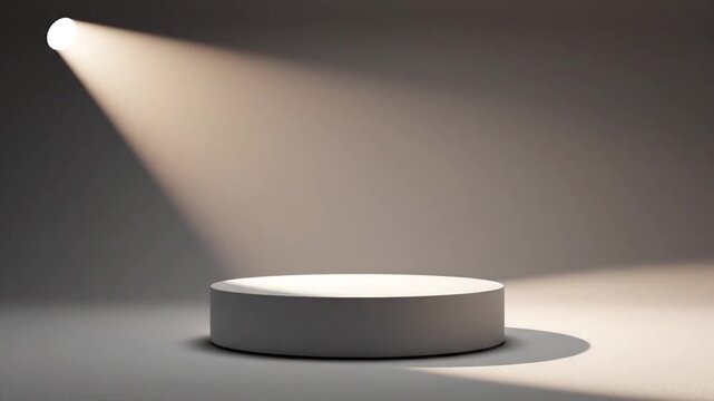 A smooth, white cylindrical podium or display stand bathed in a soft, warm spotlight from the side against a muted, neutral gray studio background with subtle shadows