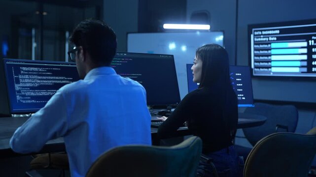 Coding team, Professional IT specialist and programmer working on software development, Male developer talking with female colleague about computer code, Modern and technology collaboration concept