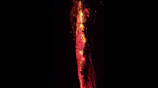 Close up of a fire log burning with sparks