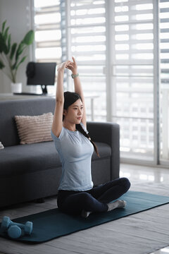 Young asian woman attractive exercises workout at home