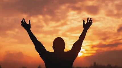 Fototapeta premium Person embracing freedom at sunset moment.