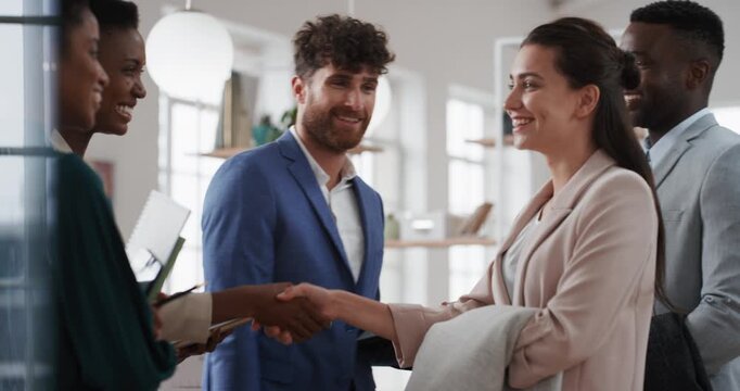 Welcome, handshake and meeting with business people in office for merger, b2b or acquisition. Partnership, introduction and shaking hands with employees in agency for consolidation, deal or thank you