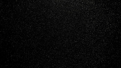 fine sparkling silver glitter texture shimmering over deep black background with cosmic night sky atmosphere