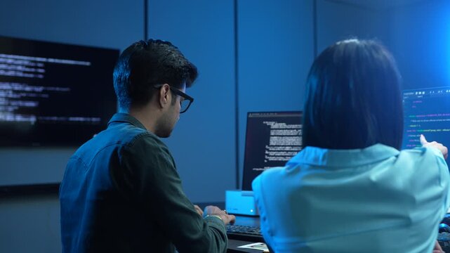 Professional IT specialist and programmer working on software development, Male developer talking with female colleague about computer code, Modern coding team and technology collaboration concept