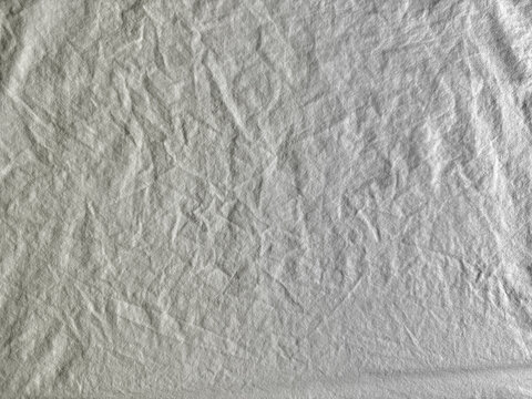 textured wrinkled grey linen fabric background with organic folds and natural soft cotton textile material abstract pattern