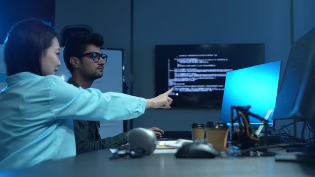 Professional IT specialist and programmer working on software development, Male developer talking with female colleague about computer code, Modern coding team and technology collaboration concept