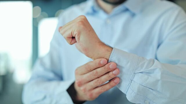 Close up of tired corporate manager or IT specialist suffering from carpal tunnel syndrome, hand cramp or joint inflammation at laptop. Stressed employee or freelance worker feeling sharp tendon pain