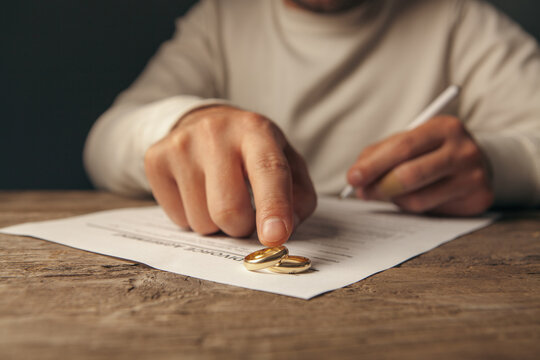 Wedding rings on a wedding contract in the hands of a man