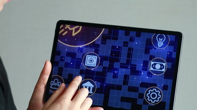 A person holds a tablet with a colorful graphic of a rocket. Their finger is touching the screen, engaging in a digital activity. The environment is simple and modern.
