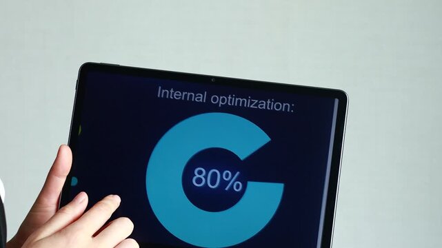 Person holds tablet showing search engine optimization data and statistics for internal and external optimization.