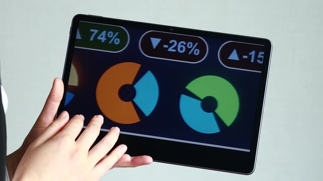 Person shows competitor analysis data on a tablet screen during a meeting in a well-lit office environment.