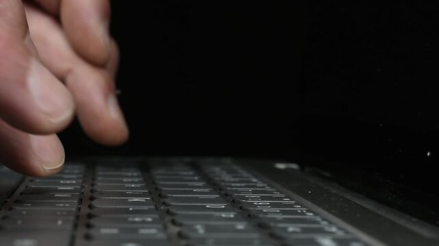 Typing on Computer on Black Background