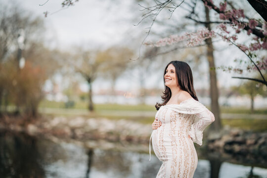 Pregnant woman smiling outdoors celebrating new life