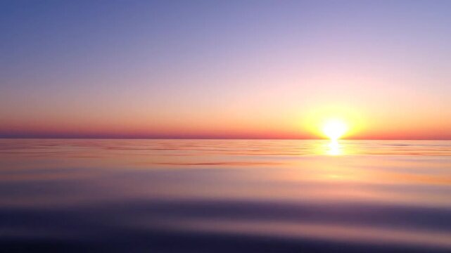 Sunset over calm ocean water horizon.
