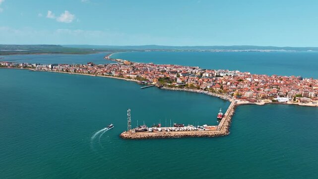 Pomorie coastal town aerial side view Black Sea Bulgaria marina pier boat drone summer travel slow motion Balkans tourism scenic overview
