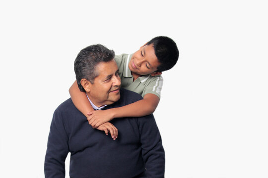 Latino single dad and his 12-year-old Latino son show their love to celebrate Father's Day