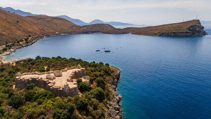 Fototapeta premium aerial drone of Porto Palermo Castle on its coastal peninsula next to the calm blue waters of the bay in southern Albania